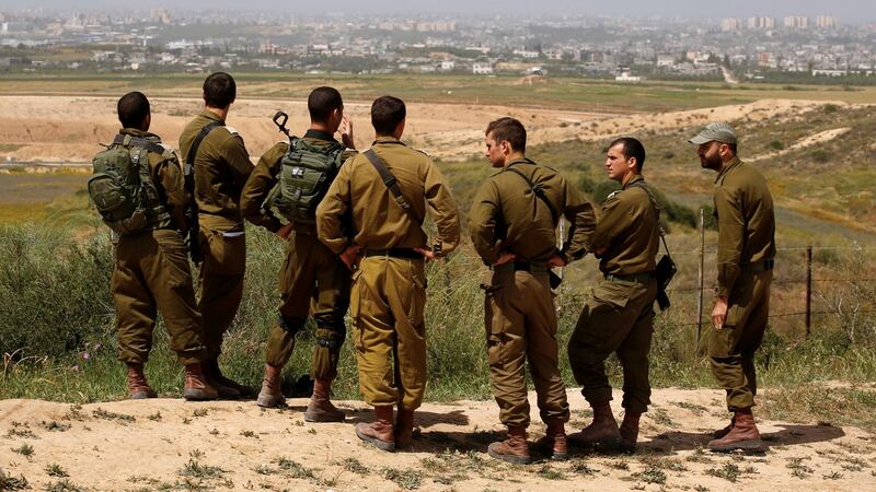 Israeli soldiers listen to a briefing on the Israeli side of the border with the northern Gaza Strip, Israel, on Thursday. Photograph: Amir Cohen/Reuters