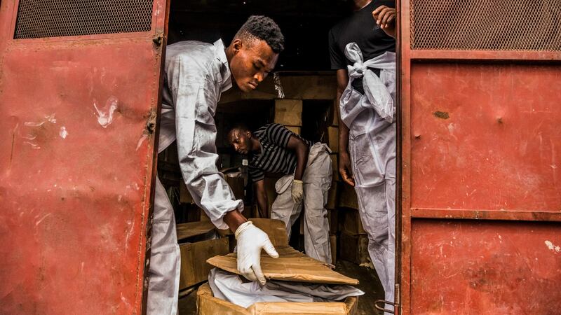 Workers from the St Luke Foundation collect abandoned bodies from the Zenith Funeral home in Port-au-Prince, Haiti. Photograph: Daniel Berehulak/The New York Times