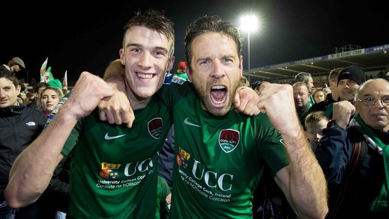 Cork City’s Ryan Delaney and Alan Bennett celebrate winning the league with supporters. Photograph: Morgan Treacy/Inpho