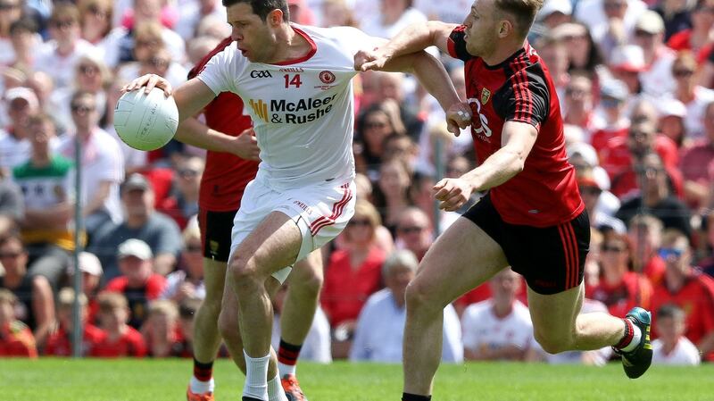 Tyrone’s Seán Cavanagh breaks through the challenge of Down’s Gerard McGovern  in Clones. He has been an inspirational leader and father figure for younger players on the team. Photograph: Philip Magowan/Inpho/Presseye