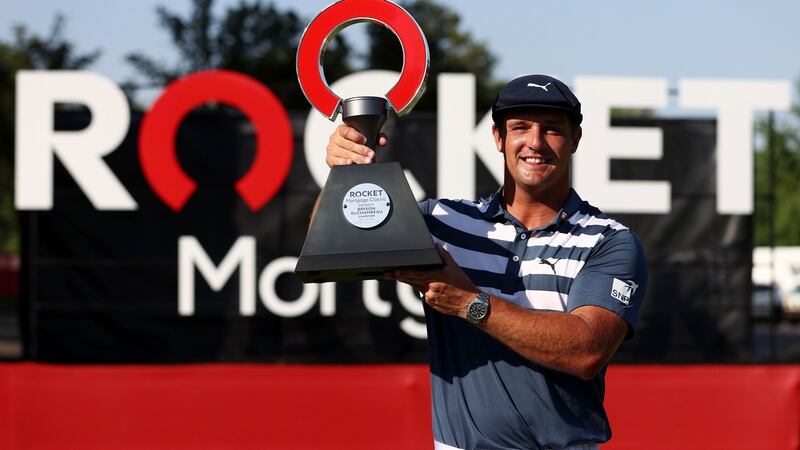 Bryson DeChambeau celebrates with the trophy after winning  the Rocket Mortgage Classic. Photograph: Gregory Shamus/Getty Images