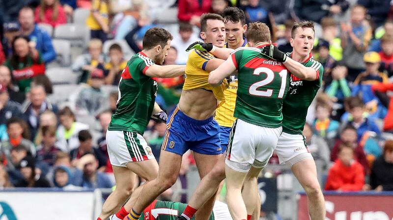 Roscommon’s John McManus confronts Mayo’s Donal Vaughan. Photo: Oisin Keniry/Inpho