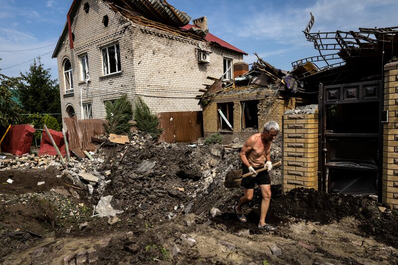 A man walks through a crater in Kramatorsk, Ukraine, on August 12th after a night of Russian shelling. Photograph: David Guttenfelder/New York Times