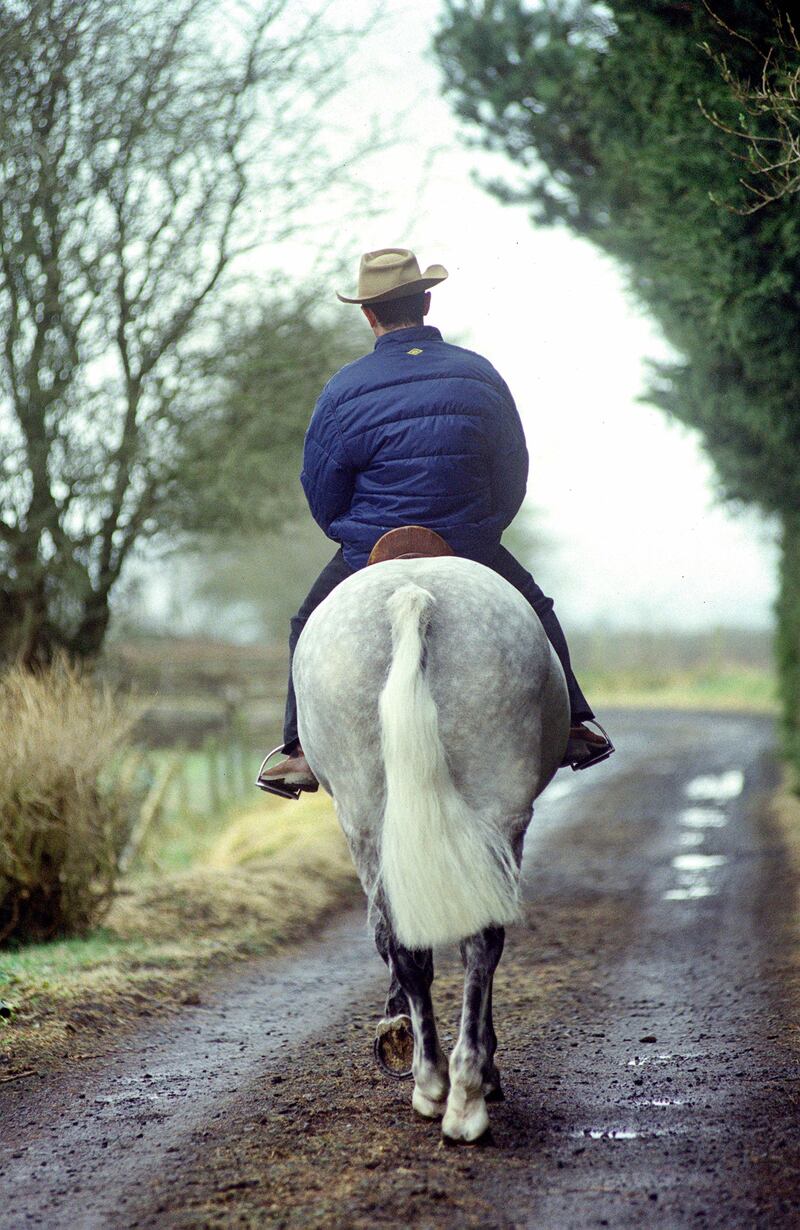 Robert Dunlop rides out on one of the horses trained by his wife, Louise, at their Ballymoney home in 2001. Photograph: Stephen Davison
