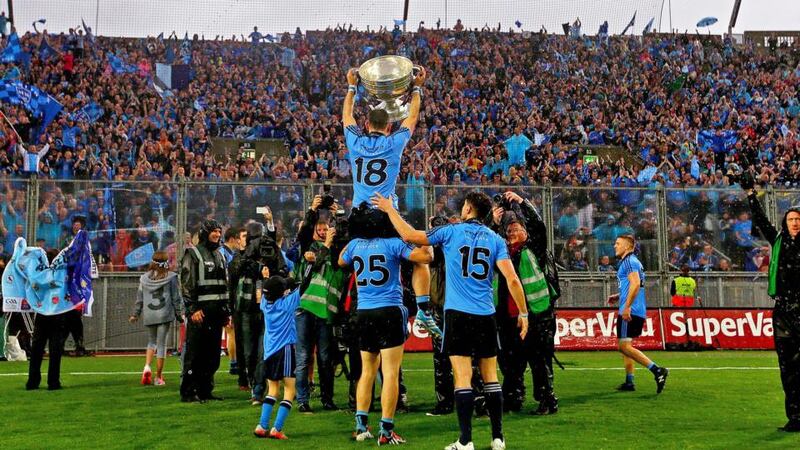 Dublin’s Alan Brogan celebrates with the Sam Maguire trophy in front of Hill 16 at Croke Park. Photograph: Donall Farmer/Inpho