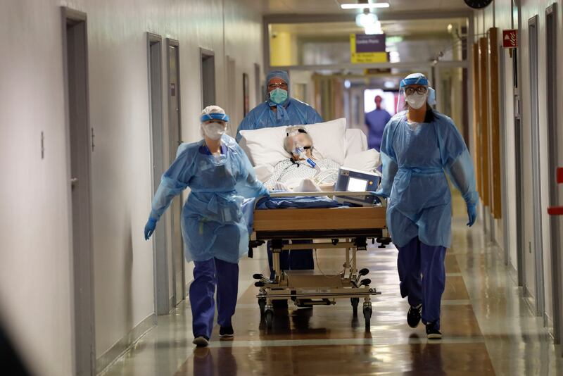 12.26am: A Covid-19 patient is transferred along hospital corridors. Photograph: Alan Betson