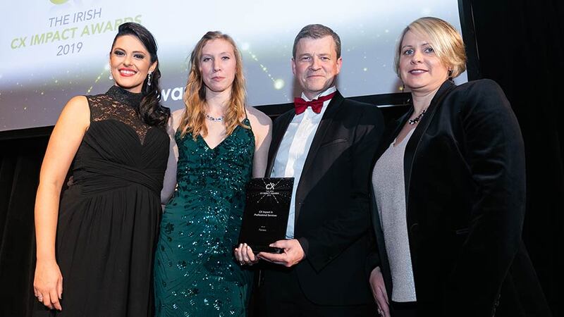 Aidan Connolly, CEO, Idiro Analytics presents the CX Impact in Professional Services award to the Fenero team.