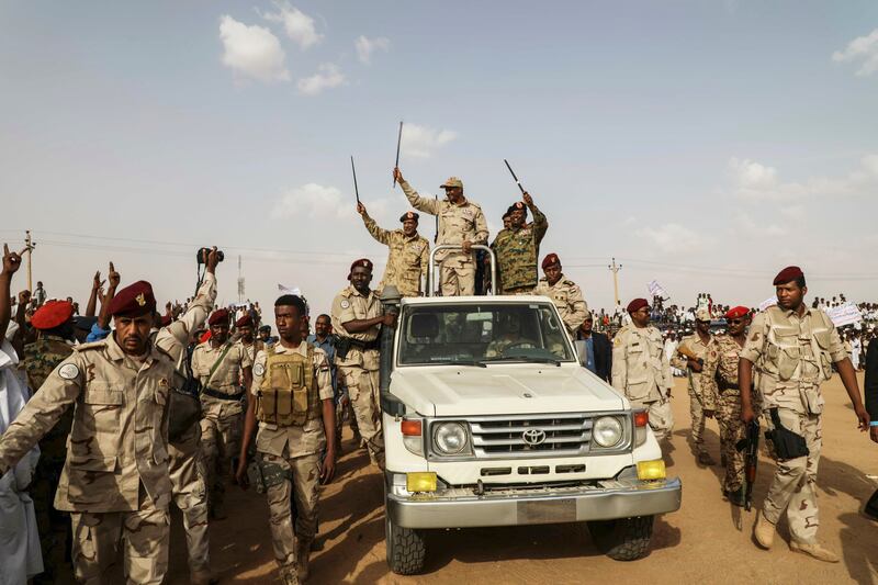 Sudanese general Mohammed Hamdan Dagalo waves to supporters during a rally in 2019. Photograph: Mahmoud Hjaj/AP