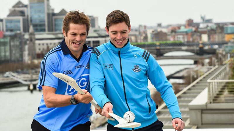 Richie McCaw gets into a ruck with Dublin hurler Paul Schutte. Photograph: Stephen McCarthy/Sportsfile