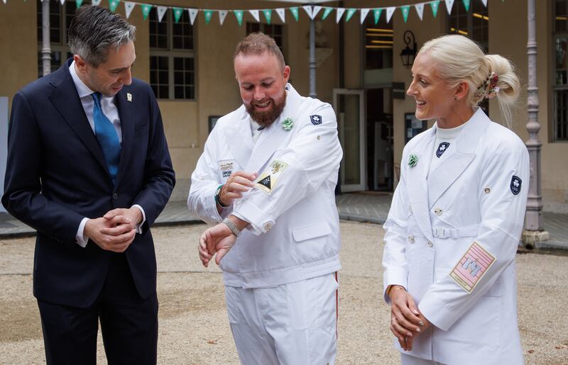 Taoiseach Simon Harris with Ireland's Opening Ceremony flag-bearers, golfer Shane Lowry and hurler Sarah Lavin. Photograph: James Crombie/Inpho