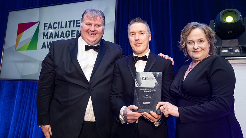 John Cunniffe, Awards Judging Co-ordinator, presents the Cleaning Service Provider of the Year Award to Niall Kelly & Aleksandra Krakowiak, Apleona HSG.