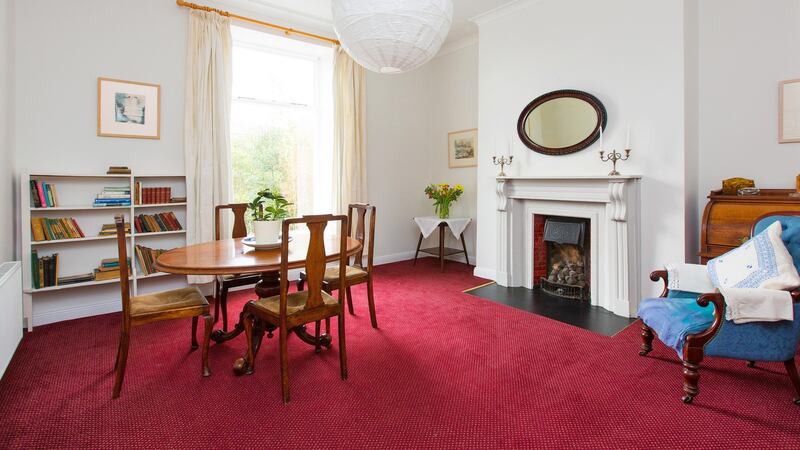 Both reception rooms opening off the front hall of 21 Mulgrave Terrace in Dún Laoghaire feature marble fireplaces.