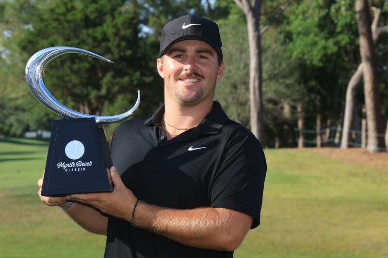 Chris Gotterup poses for a photo with the trophy after the final round of the Myrtle Beach Classic at Dunes Golf & Beach Club. Photograph: Sam Greenwood/Getty Images