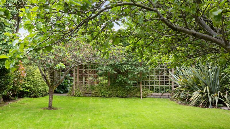 Past the  trellised arch is a secret garden complete with timber play house.