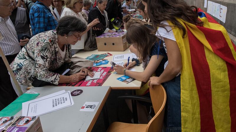 University students help citizens to identify where they can  vote in the Catalan  referendum on October 1st, which has been deemed illegal by the Spanish government in Madrid. Photograph:  David Ramos/Getty Images