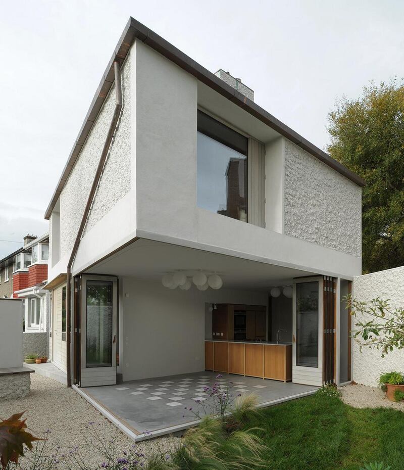 The downpipe has been carefully placed on the wall 'like a line drawing' and the timber slats on the doors exactly match the width of the latches.