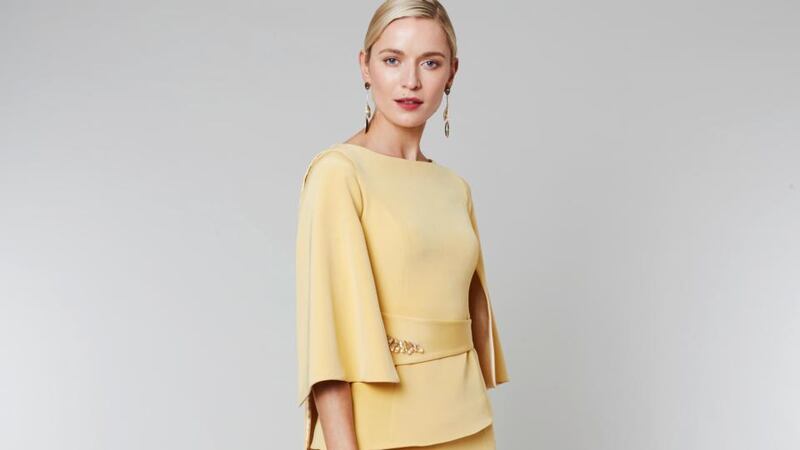 Keri – two-piece with wide cape sleeves and belt detail with crystal embellishments and an asymmetrical hemline skirt. Approx €1,600.