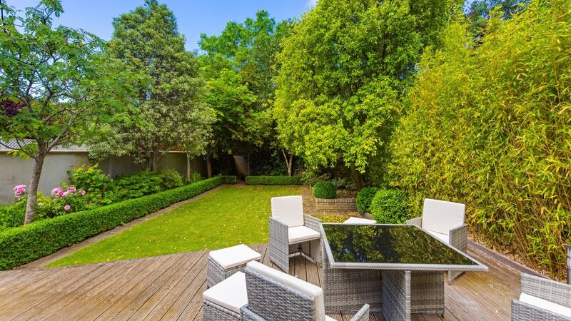 Back garden with pedestrian access.