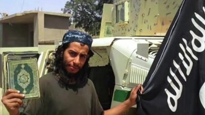 A grab made from an undated video released by the jihadist group calling itself Islamic State (IS) allegedly showing Abdelhamid Abaaoud posing with a Koran and the ISIS flag at an undisclosed location. French police claimed on Thursday that he had been killed during a shootout in the Paris suburb of St-Denis on Wednesday.