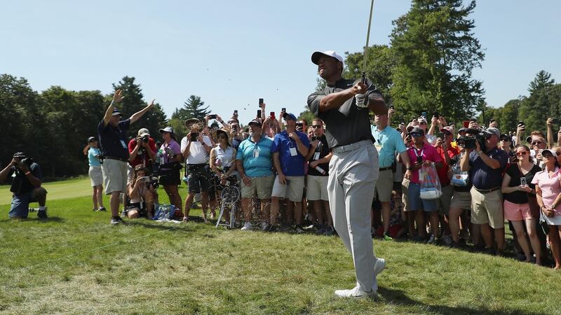 Woods plays his approach to the second. Photo: Patrick Smith/Getty Images