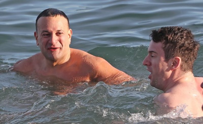 Taoiseach Leo Varadkar and his partner Matt Barrett take part in the annual Christmas day swim at the Forty Foot bathing spot in Sandycove Dublin. Photograph: Niall Carson/PA