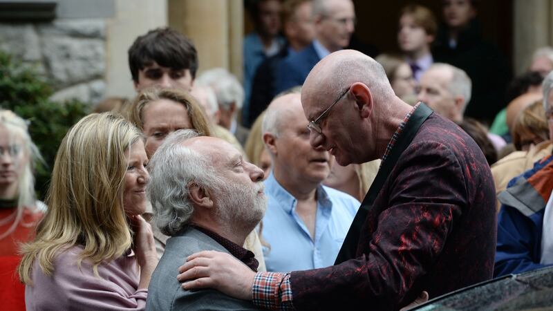 Brian Keenan sympathises with Ferdia Mac Anna, husband to the late Irish Times journalist  Kate Holmquist at her funeral service at St Pauls Church, Silchester Road, Glenageary, Dublin, on Friday. Photograph: Alan Betson/The Irish Times