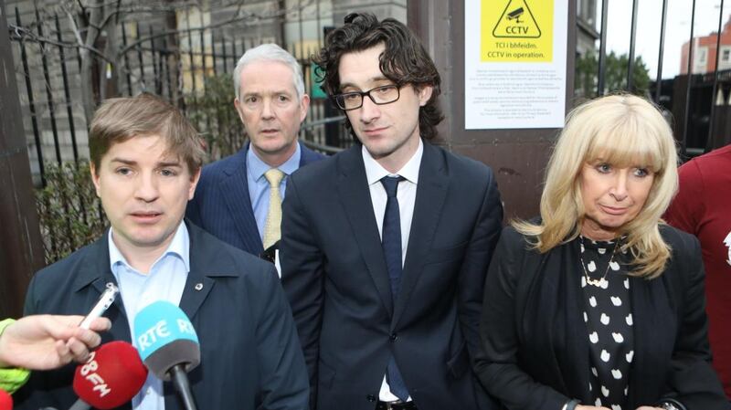 Journalist Tom Lyons speaks to the media following the verdict in the High Court on Friday, flanked by solicitor John Doyle, former Sunday Business Post Editor Ian Kehoe and the newspaper’s chief executive, Siobhán Lennon. Photograph: Collins Courts