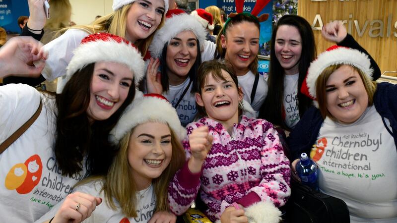 Nastia Sivakova, one of the  visitors who arrived at Dublin Airport on Tuesday for a Christmas visit to Ireland, is pictured with  Dublin Rose contestants. Photograph: Cyril Byrne/The Irish Times.