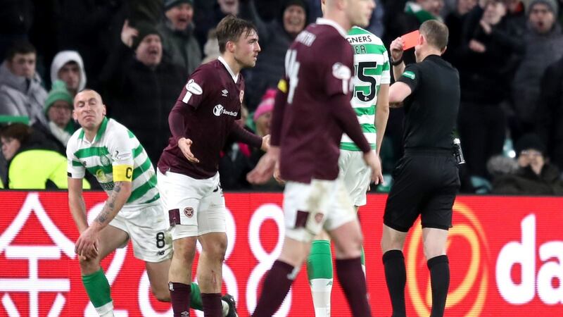 Hearts’ Marcel Langer is shown a red card for a tackle on Scott Brown. Photograph: Jane Barlow/PA