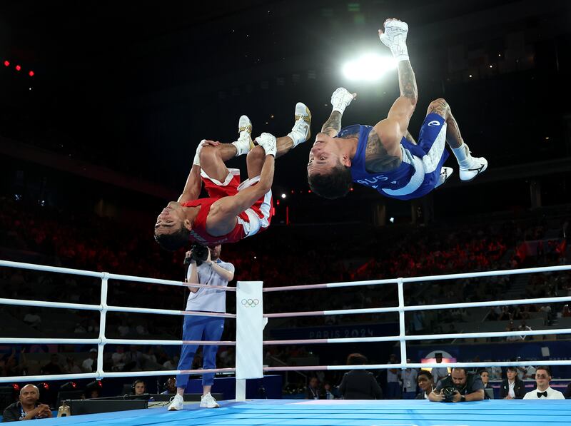 Abdumalik Khalokov of Uzbekistan and Charlie Senior of Australia perform synchronised back flips after the boxing men's 57kg semi-final at the Olympic Games. Photograph: Richard Pelham/Getty Images
