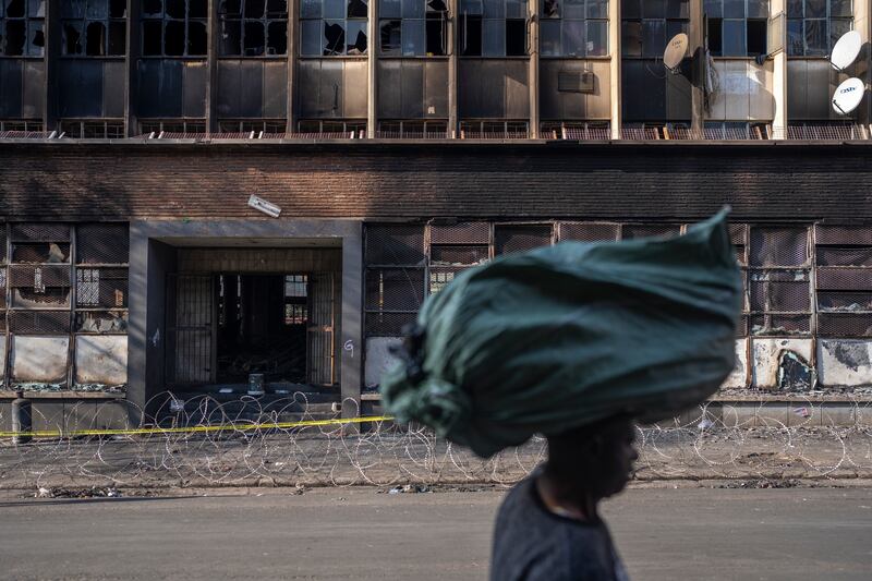Families are still searching for relatives at mortuaries and hospitals a day after the blaze tore through an overcrowded building in one of the worst residential fires in South African history. Photograph: Joao Silva/New York Times
                      