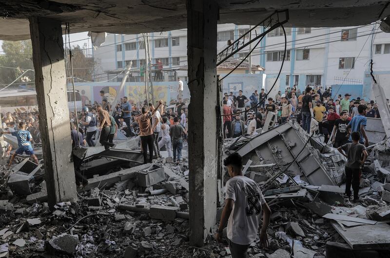 Palestinians search for bodies and survivors in the rubble of a residential building leveled in an airstrike, in the Khan Younis refugee camp in the southern Gaza Strip on Saturday. Photograph: Haitham Imad/EPA