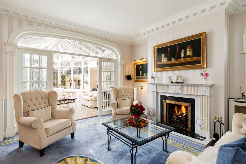 The drawing room opens into a conservatory at the front of the house, which in turn opens into a large, private front patio.