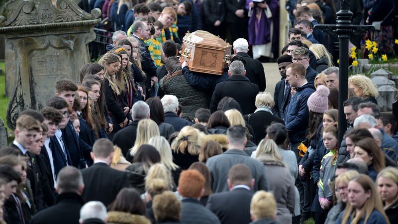 Mourners flank the pall-bearers at Conor Currie’s funeral. Photograph:  Charles McQuillan/Getty