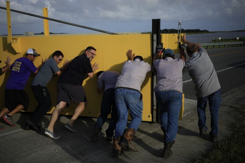 Crews work to secure a levee flood gate across Louisiana Route 1 ahead of Hurricane Ida. Photograph: Luke Sharrett/Bloomberg