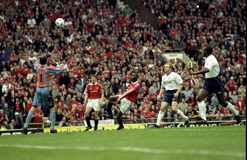 Andy Cole lobs Tottenham Hotspur goalkeeper Ian Walker to score the winning goal that secured the Premiership title for Manchester United. Photograph: Shaun Botterill /Allsport