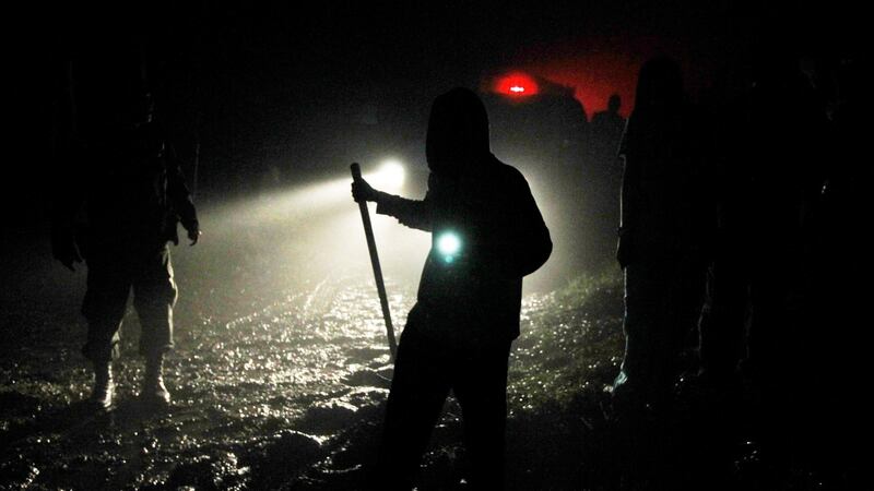Rescue crews work in darkness at the scene of the crash. Photograph: Fredy Builes/Reuters