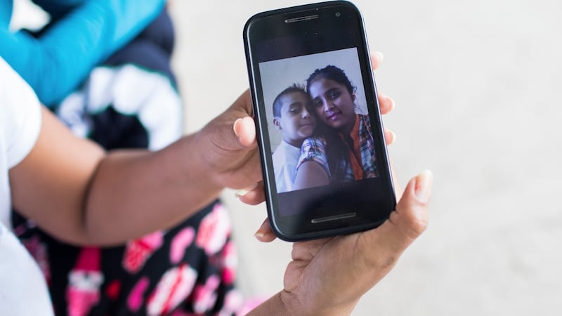 Elsa Johana Ortiz Enriquez shows a picture of her and her son Anthony on her mobile phone. Photograph: Marian Carrasquero/The New York Times