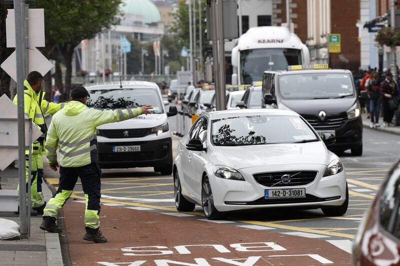 Dublin City Council workers on Burgh Quay as a ban on private vehicles travelling on sections of the north and south quays in Dublin city centre comes into effect today.  Photograph: Nick Bradshaw for The Irish Times