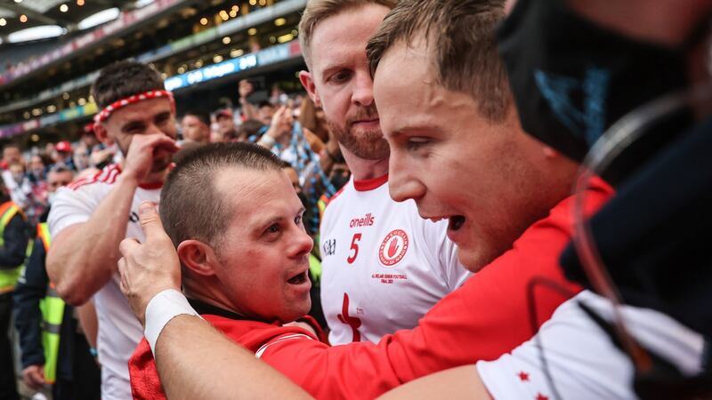 Padraig Hampsey, Frank Burns and Kieran McGeary of Tyrone celebrate with fan Patrick Traynor at Croke Park. Photograph: James Crombie/Inpho