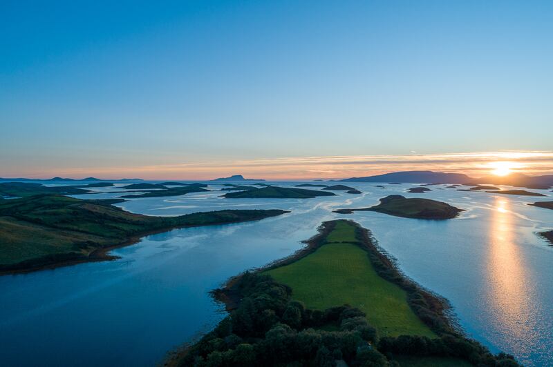The sun sets over Clew Bay, where John Lennon once owned an island named Dorinish