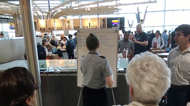 British Airways staff writing gate information on a white board at Heathrow Airport, as the airline is “experiencing a global system outage”.  Photograph: @theboyg/PA Wire