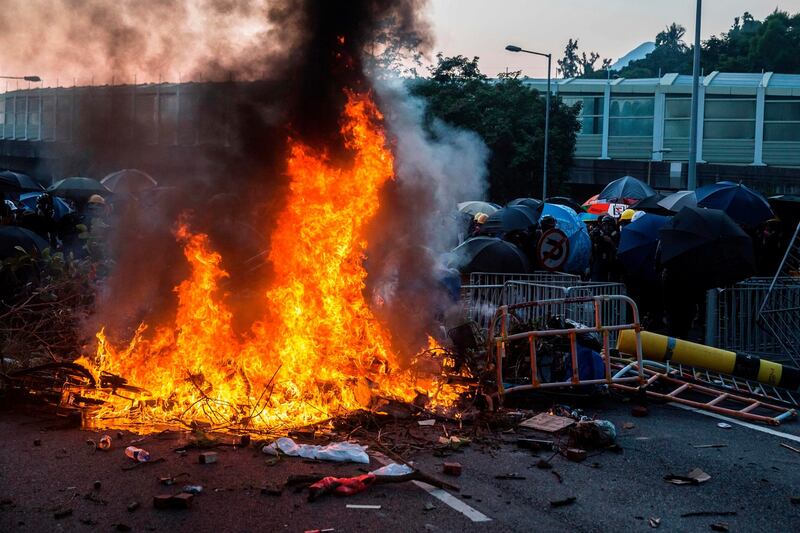 A fire lit by protesters burn in the Sha Tin district of Hong Kong. Photo: Isaac Lawrence / AFP