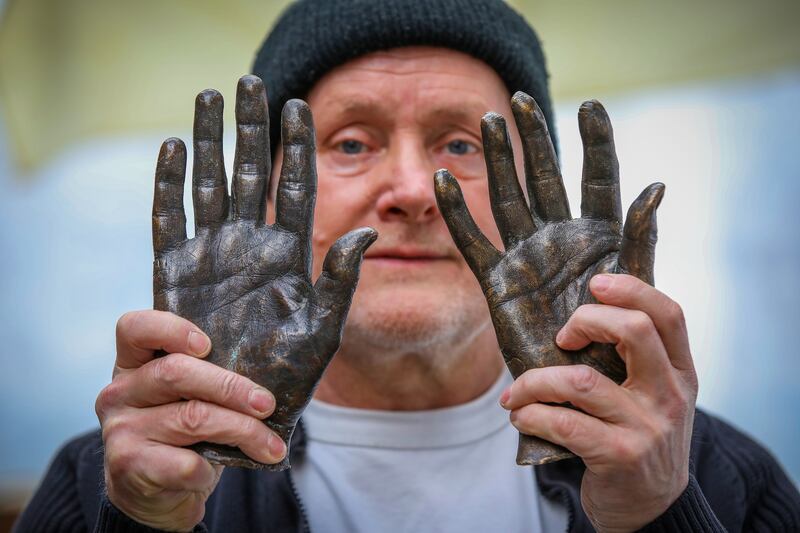 Sculptor Raymond Watson with his Hands of History. Photograph: Paul Faith 