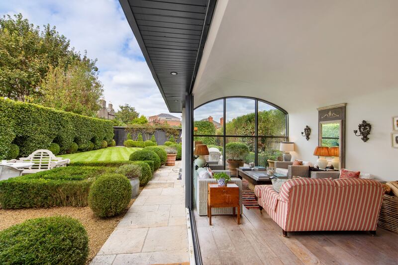 The extension opens to a courtyard garden full of topiary buxus