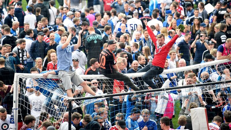 Hamburg fans celebrate on the pitch after the game. Photo: Fabian Bimmer/Reuters