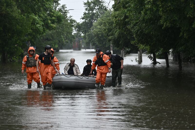 Rescuers from the State Emergency Service help evacuate a local resident from a flooded area in Kherson on Sunday. Photgraph: Genya Savilov/AFP via Getty