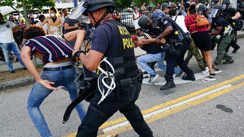 Police detain protesters for being in the street during a protest in response to the police killing of George Floyd  in Atlanta, Georgia. APhotograph: Elijah Nouvelage/Getty Images