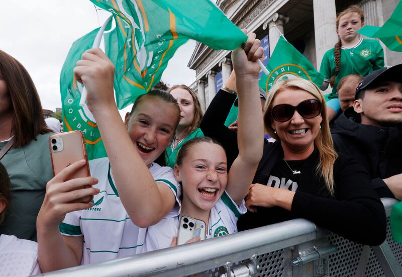 Brooke Ward and Aoibhe Galvin who play for Ballyfermot United with Anita Turner at the homecoming on Dublin's O'Connell Street. Photograph: Alan Betson