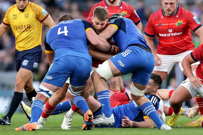 mbes is tackled by Jason Jenkins and Caelan Doris of Leinster at the Aviva Stadium. Photograph: Laszlo Geczo/Inpho 